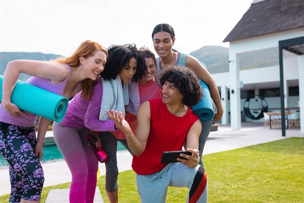 diverse friends using smartphone holding yoga mats garden 13339 329955